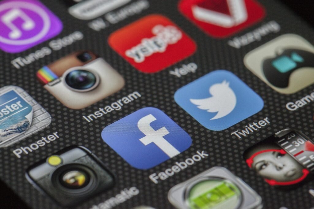 twitter-facebook-together-exchange-of-information-147413-147413 Close-up image of various social media app icons on a smartphone screen.